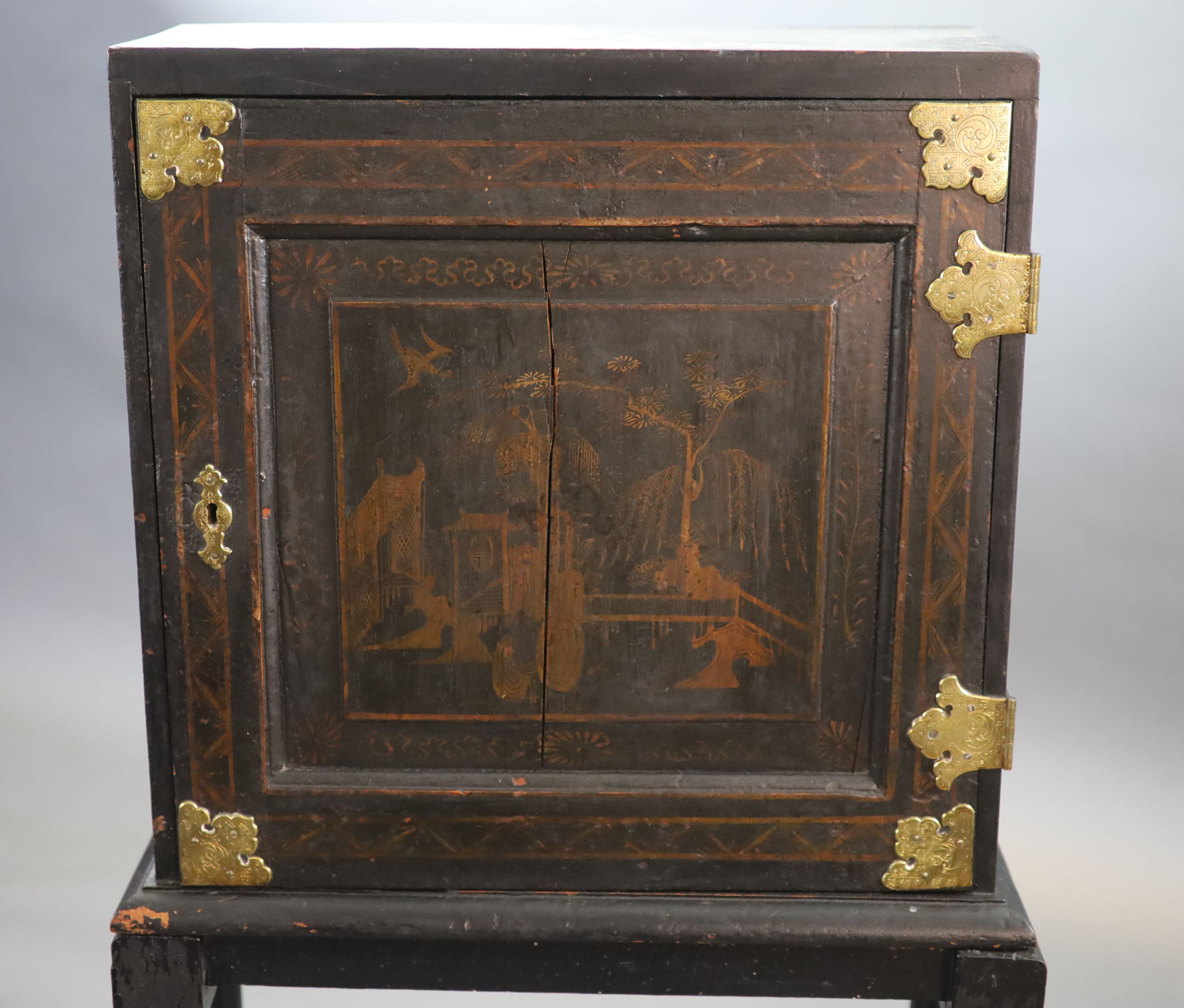 An early 18th century European japanned cabinet on stand, W.54cm D.24cm H.115.5cm